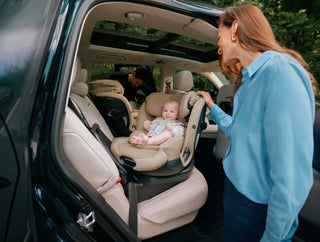 Baby car seat securely installed in a vehicle’s back seat.